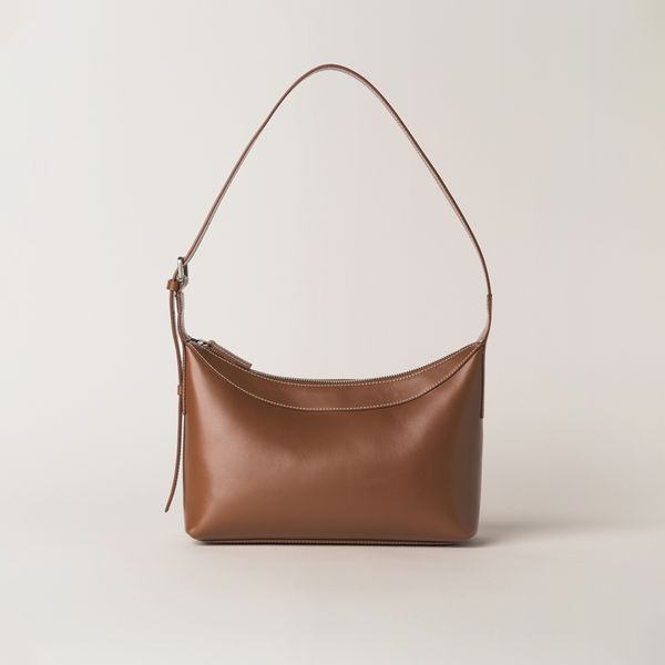 Minimal brown shoulder bag against a light background